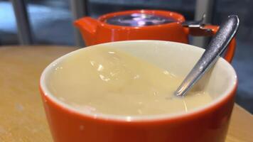 schwarz Tee mit Milch Gießen Milch in schwarz Tee oben Sicht. frisch gebraut Grün Tee Zeremonie Verfahren, gesund Morgen, Entgiftung trinken. video