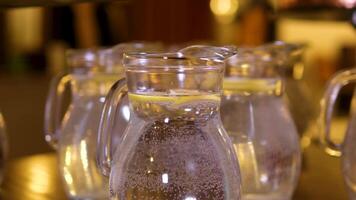 measures water into a glass jug standing on an electronic scale. Preparation of yeast dough for pizza. video