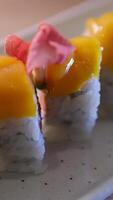 Front shot of a Japanese chef prepares a plate of sushi sashimi plate with raw fish in a sushi-bar. Closeup on hands. video