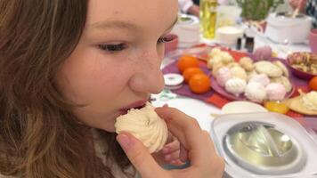 Close-up, a woman eats marshmallows on a pink background. video