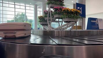 Luggage with stickers on baggage carousel in airport, close-up. Tourism i related loopable cartoon animation video