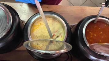 Romanian cuisine different types of soups in pots scoop with a ladle scatter on plates stir delicious aromatic food cooking recipes large selection local soup dish. footage of Brasov in Romania. video
