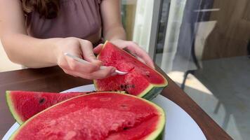 aan het eten watermeloen met een plastic lepel plak van watermeloen gegeten weg beet door beet video