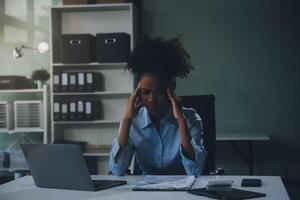 business woman sitting at work stressed , out working hard Feeling stressed out and dizzy from your job photo