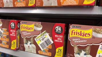 Friskies cat food on store shelves different flavors colors tin cans prices slow motion at Walmart Canada Vancouver video