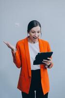 Smiling caucasian young woman girl freelancer student using digital tablet, having idea, pointing upwards on copyspace, surfing on social media, mobile applications, e-learning isolated in white photo