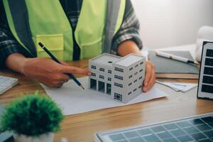Wind energy engineer designing and developing project for residential district photo