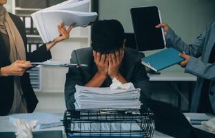 Stressful business man have so many paperwork in the office photo