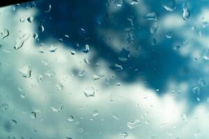 Water drops on glass against blue sky. Window view background screensaver. Place for text banner. photo