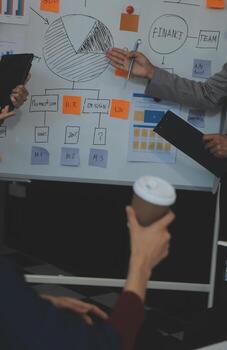 Financial analysts analyze business financial reports on a digital tablet planning investment project during a discussion at a meeting of corporate showing the results of their successful teamwork. photo