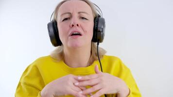 A young girl listens to headphones and interacts with the music video