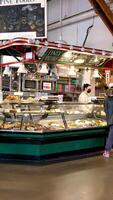 During lunch a lot of people come to buy fresh hot food they stand in line mostly elderly people this is in downtown vancouver on Granville Island video