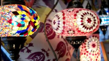 Turkish lamps in the store on the counter are multi-colored lamps turned on And glow in a mosaic shimmer in the frame the camera slowly swims by filming them Granville Island video