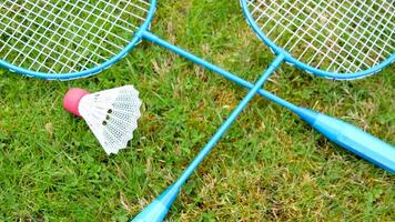 Badminton game rackets and shuttlecock on grass video
