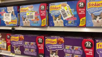 Friskies cat food on store shelves different flavors colors tin cans prices slow motion at Walmart Canada Vancouver video