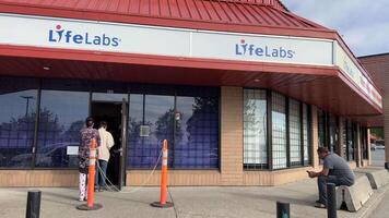 LifeLabs Laboratory for blood tests main entrance to the laboratory for testing doors inscriptions people waiting for their turn signboards day video