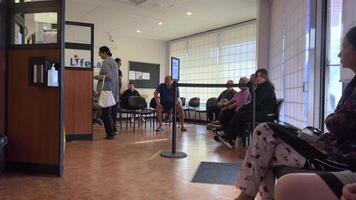 LifeLabs Laboratory for blood tests people stand in line waiting for their tests in the office in the clinic taking live queue record workers masks treatment waiting for the diagnosis sit in lobby video