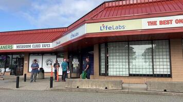 LifeLabs Laboratory for blood tests main entrance to the laboratory for testing doors inscriptions people waiting for their turn signboards day video