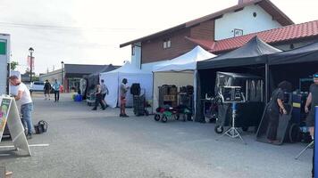 a tent city for filming trailers people rushing getting ready for filming a famous actress has arrived You can't enter the fence of the tent rain protection cooking Vancouver Canada 2023 video