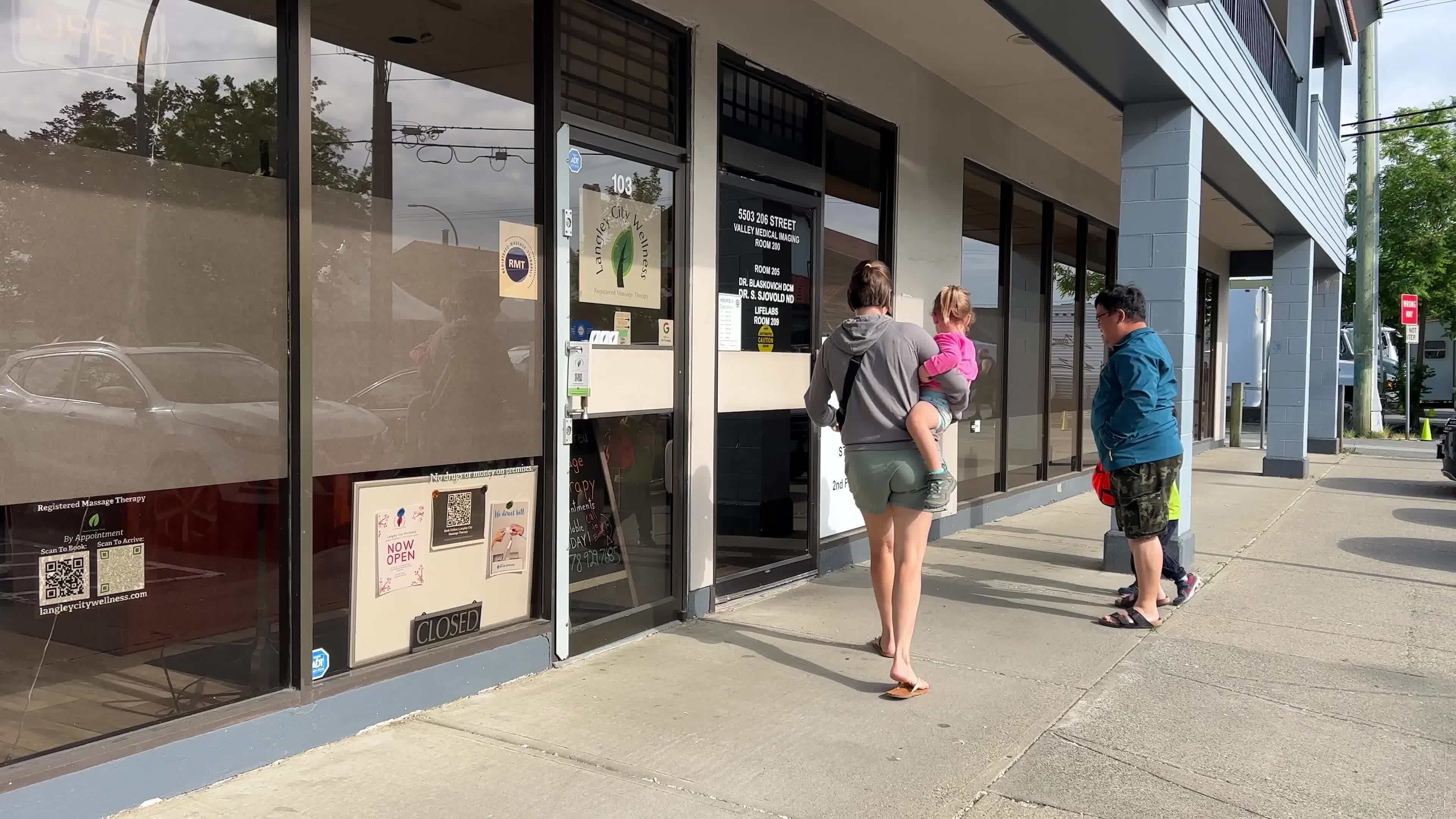 people entering the door of the polyclinic with small children Langley Medical Diagnostic Centre