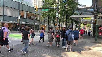 real time people's lives in Vancouver Canada central streets walks rush to work life their lives cars people men women tourists Roadway tall buildings skyscrapers shops video