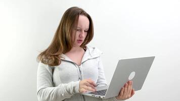 flicka argt missnöjd skriver text på bärbar dator tangentbord problem lösning problem ovillighet till studie textning med vän gräl på vit bakgrund i studio grej tonåring ungdom psykos video