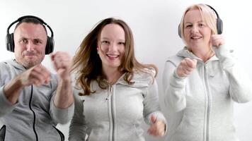 mom dad and daughter boxing with fists in frame with headphones family dancing fun pastime on white background blow close up be cheerful celebrate Listen to music dance sport beautiful people leisure video