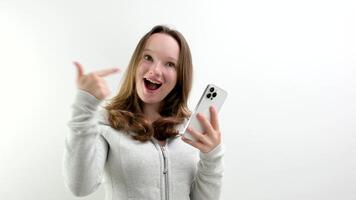 Look Here. Happy Woman Showing Blank Smartphone Screen and Pointing On It, white Background video