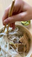 Pho Bo is a Vietnamese fresh rice noodle soup with beef, herbs and chili. Vietnamese national dish. video