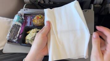 Vietnam Phu Quoc 05.02.2024 Cutlery on airplane food Airline meal and beverage served on seat tables during flight. video
