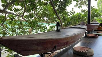 Boat-shaped table boat shape shelves on wooden table. product display background, vintage filtered video