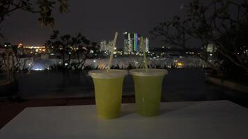 Two drinks against the backdrop of the night city Two glasses clink against the backdrop of the night city video
