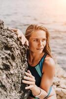 Woman travel summer sea. A happy tourist in a blue bikini enjoying the scenic view of the sea and volcanic mountains while taking pictures to capture the memories of her travel adventure. photo