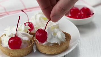 Baskets of pastries with cherry and cream. tartlets with soft cream and cherries. Creamy cake with fresh berries video