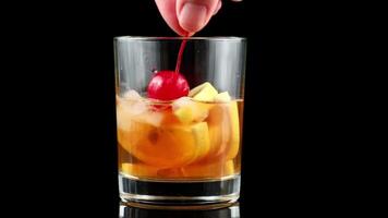 Lemon cocktail with cherry, honey and ice. alcohol cocktail with lemon slices and cherry video