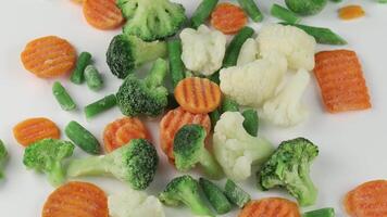 Frozen vegetables close-up on a white background. video