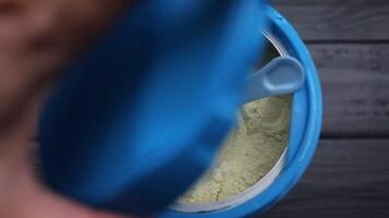 Protein in a jar. Sports nutrition powder and spoon. video