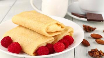 Pancakes with berries. Crepes with Fresh Berries. Plate with tasty pancakes and berries video