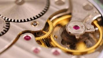 Clock mechanism close-up. Gears and cogs in clockwork watch mechanism video