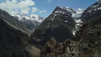 Drone flight through snowy mountain peaks, rocky. video