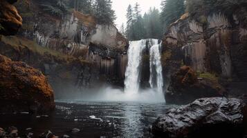 Majestic waterfall cascading down moss-covered rocks into refreshing pool below photo