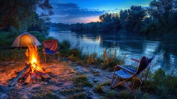 Peaceful riverside campsite illuminated by the flickering light of campfire photo