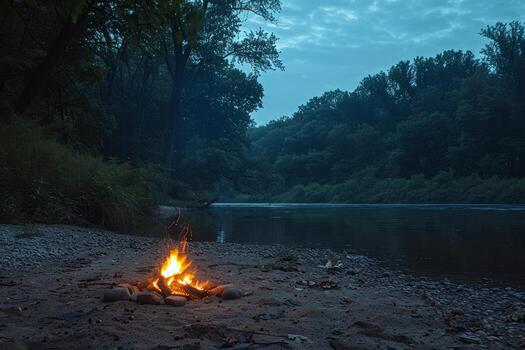 Peaceful riverside campsite illuminated by the flickering light of campfire photo