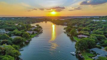 Sunset over tranquil lake, casting warm glow over the water and surrounding landscape photo