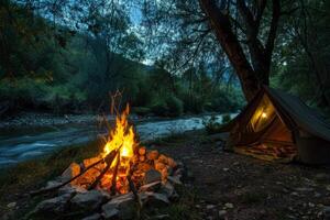 Peaceful riverside campsite illuminated by the flickering light of campfire photo