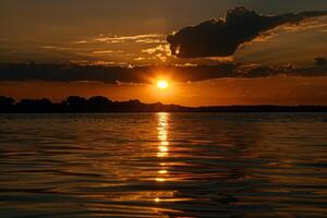 puesta de sol terminado tranquilo lago, fundición calentar resplandor terminado el agua y rodeando paisaje foto