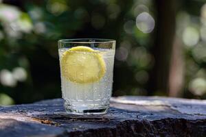 Refreshing glass of lemonade, condensation glistening in the summer heat photo