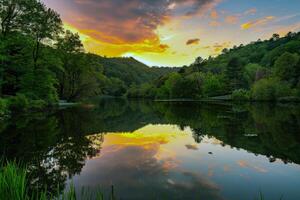 Sunset over tranquil lake, casting warm glow over the water and surrounding landscape photo