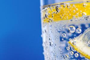 Refreshing glass of lemonade, condensation glistening in the summer heat photo