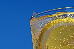 Refreshing glass of lemonade, condensation glistening in the summer heat photo